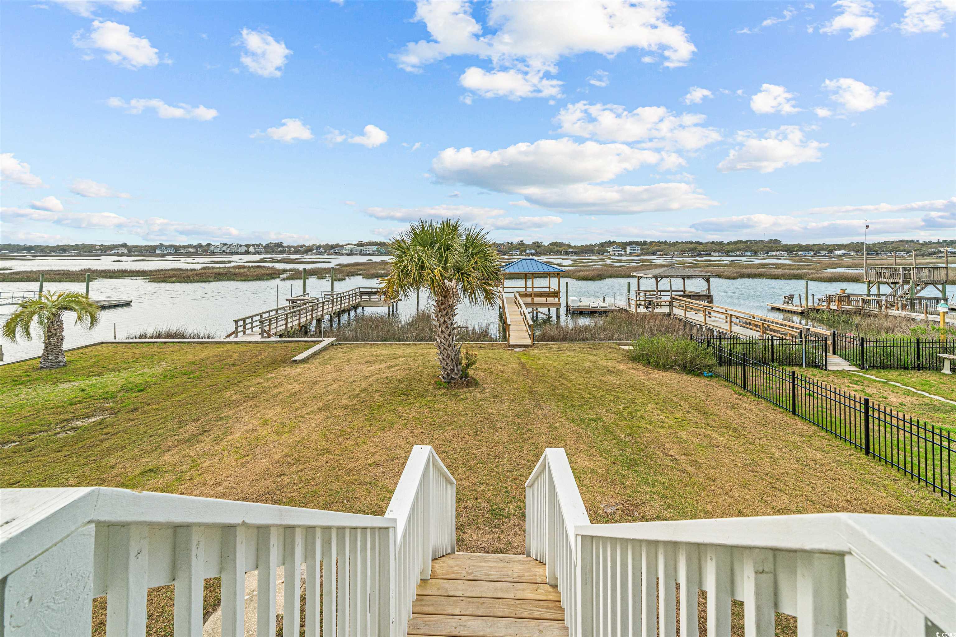 338 State Rd S-26-530 Murrells Inlet, SC 29576 - Photo 23 of 39 View of dock with a water view, fence, and a yard