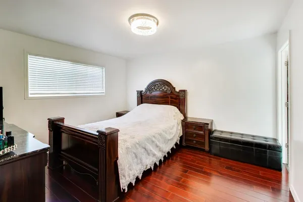 a bedroom with bed and a window
