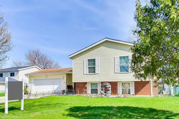 a front view of house with yard and green space