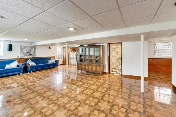 a an empty room with wooden floor and furniture