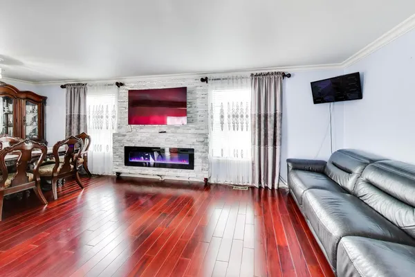 a living room with furniture a flat screen tv and a fireplace