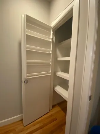 a view of walk in closet with empty racks