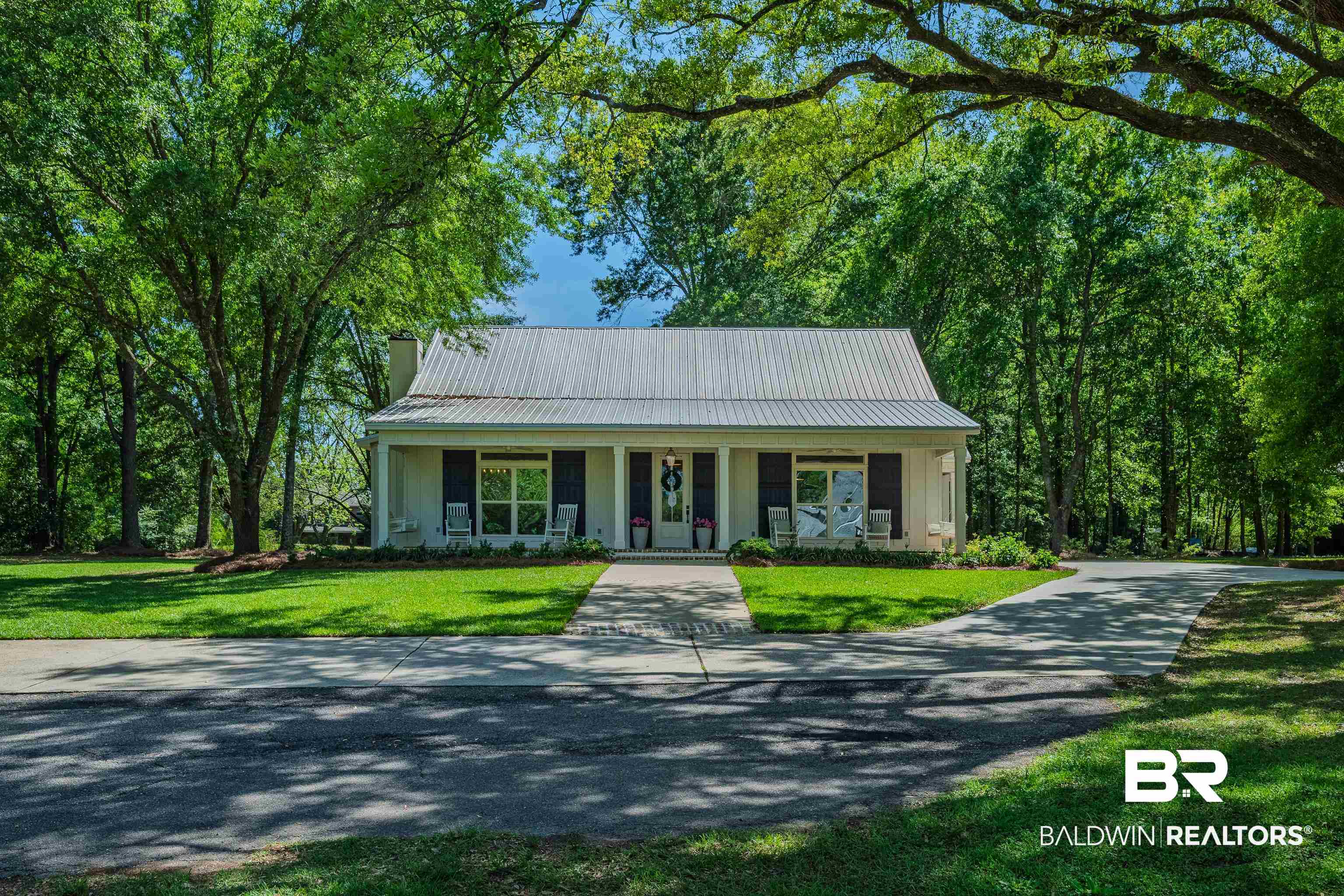 19121 Boothe Road Fairhope, AL 36532 - Photo 36 of 41 View of front of property with a porch, a metal roof, a front lawn, and driveway