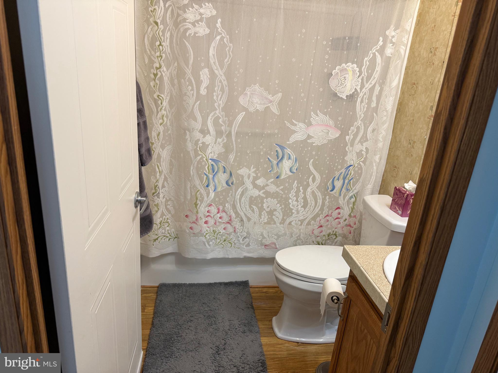 821 Rum Bridge Branch Road Seaford, DE 19973 - Photo 11 of 15 a white toilet sitting next to a shower curtain