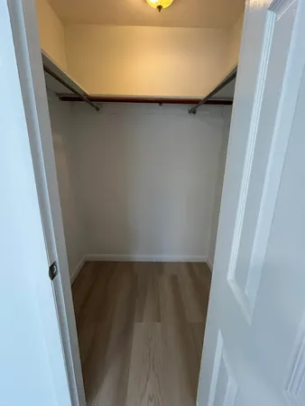 a view of a room with wooden floor