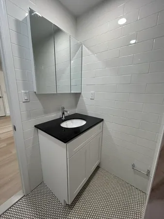 a view of a hallway with wooden floor and entryway