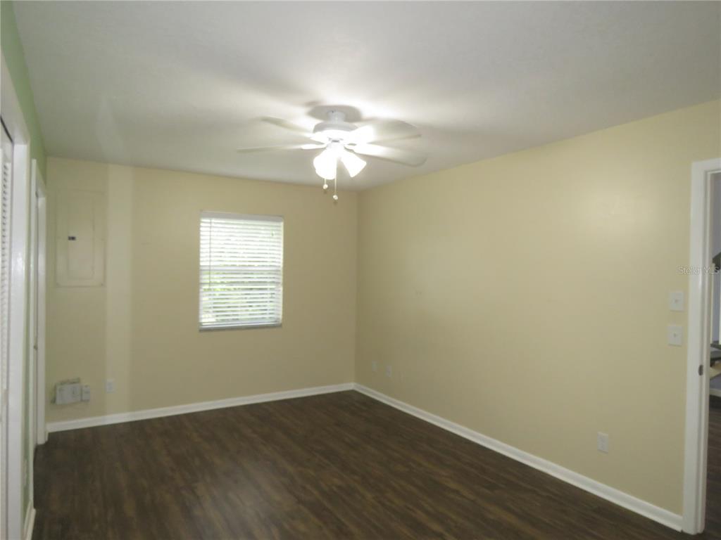 418 Narvaezi Street Venice, FL 34285 - Photo 13 of 67 an empty room with wooden floor and windows