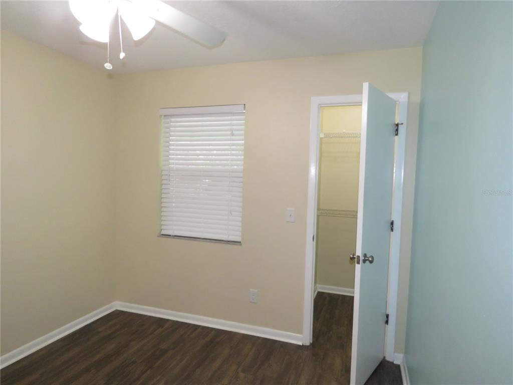 418 Narvaezi Street Venice, FL 34285 - Photo 19 of 67 a view of an empty room with wooden floor and a window