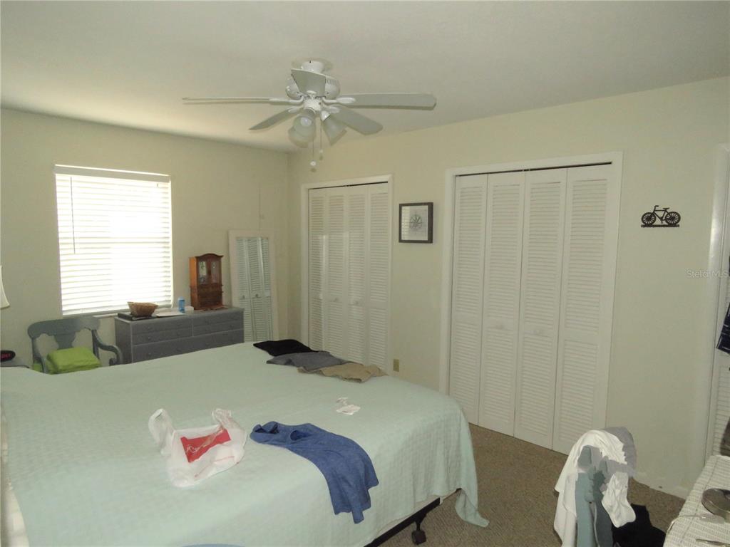 418 Narvaezi Street Venice, FL 34285 - Photo 30 of 67 a bedroom with a bed and a chandelier