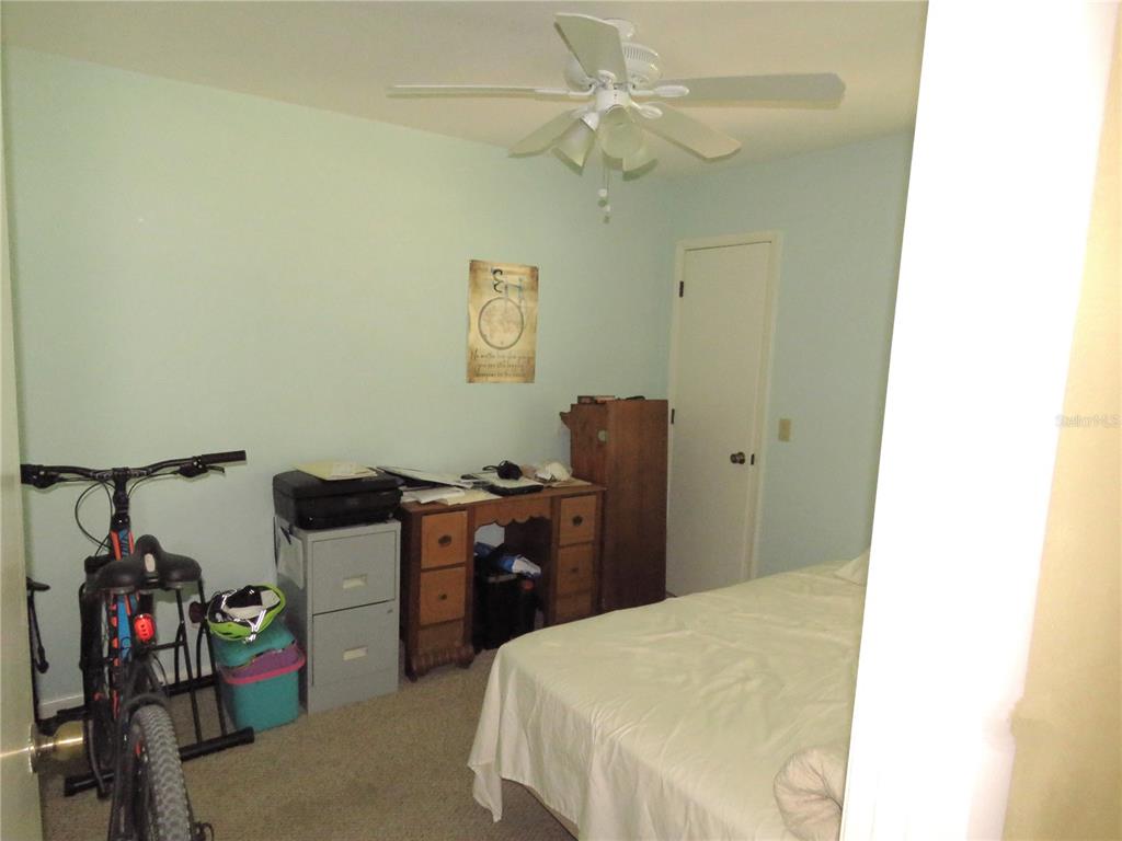418 Narvaezi Street Venice, FL 34285 - Photo 35 of 67 a bedroom with a bed and a chandelier