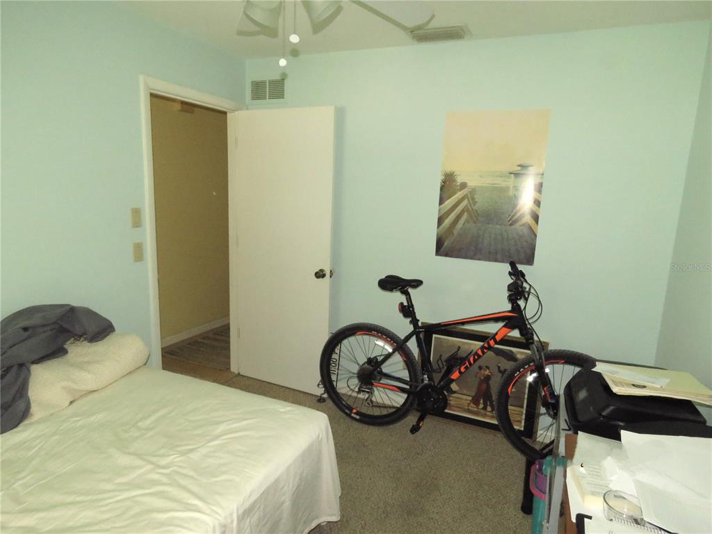 418 Narvaezi Street Venice, FL 34285 - Photo 36 of 67 a bedroom with a bed and a chandelier