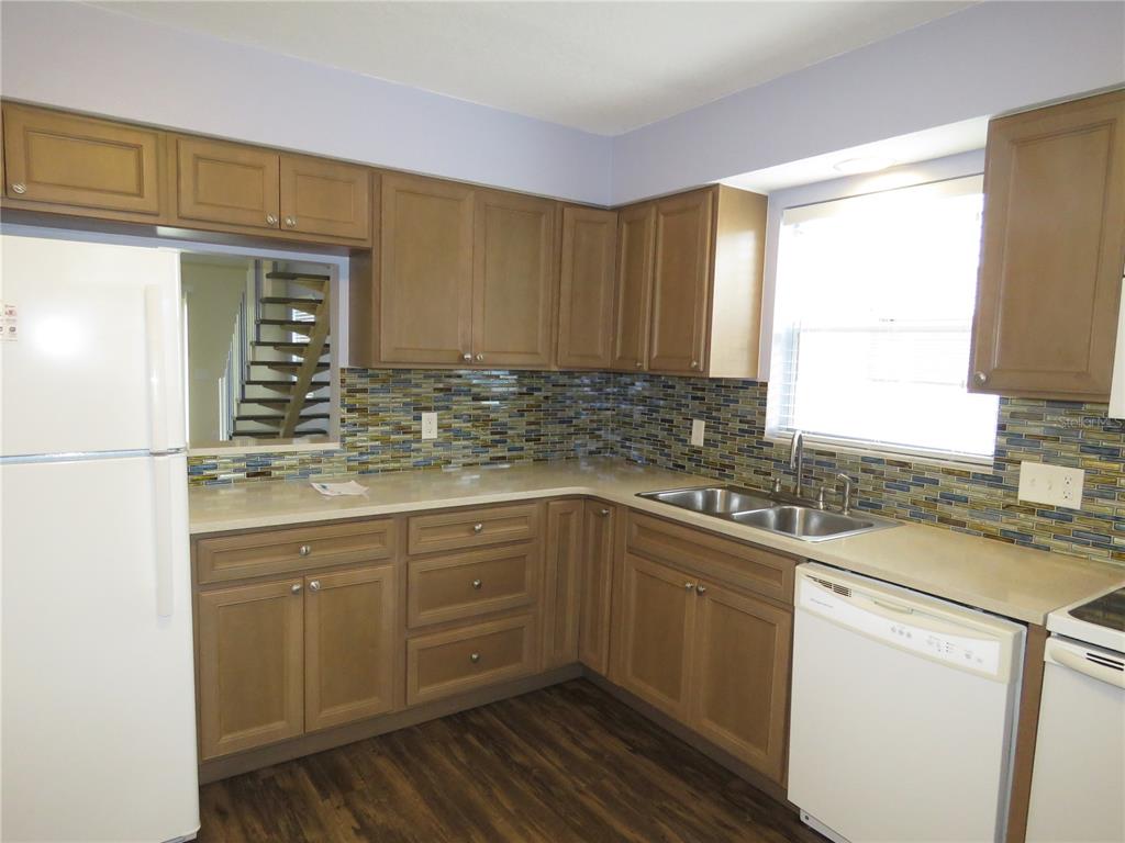 418 Narvaezi Street Venice, FL 34285 - Photo 5 of 67 a kitchen with a sink stove and cabinets