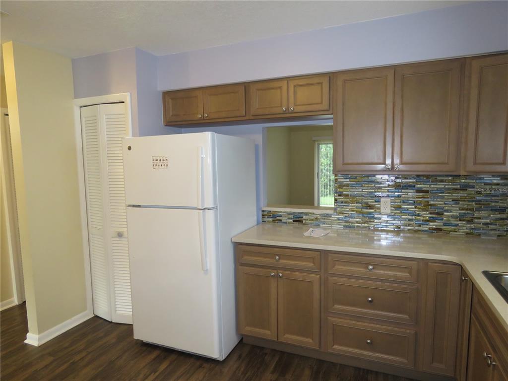418 Narvaezi Street Venice, FL 34285 - Photo 6 of 67 a kitchen with cabinets and stainless steel appliances