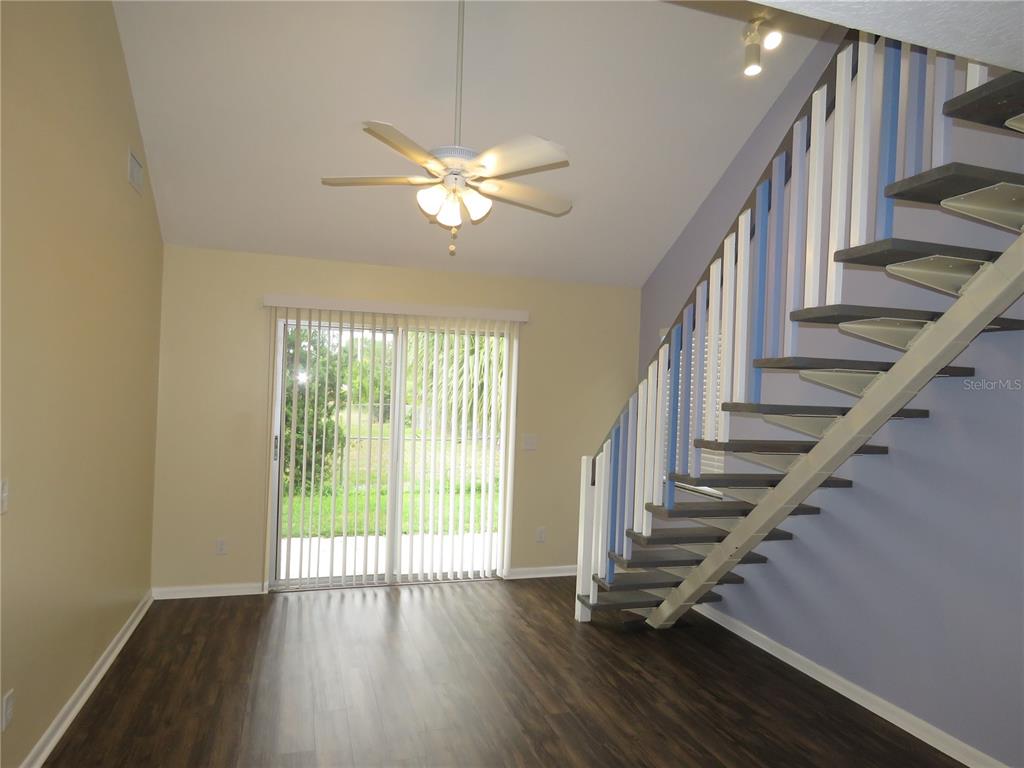 418 Narvaezi Street Venice, FL 34285 - Photo 8 of 67 a view of staircase with wooden floor and fan