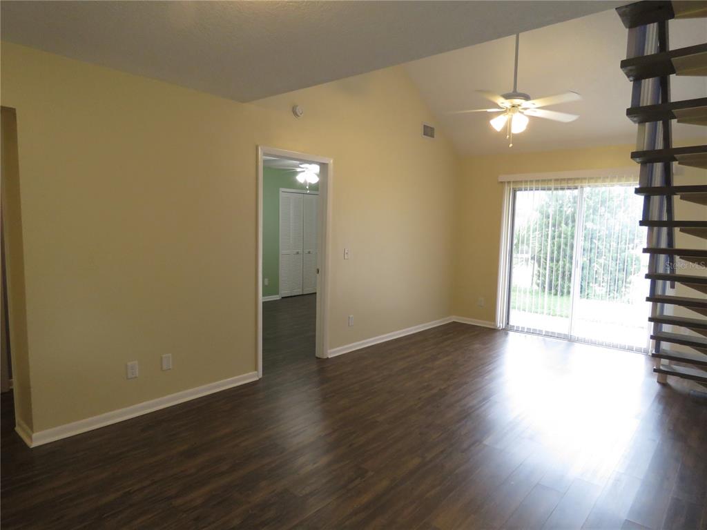 418 Narvaezi Street Venice, FL 34285 - Photo 9 of 67 an empty room with wooden floor and windows