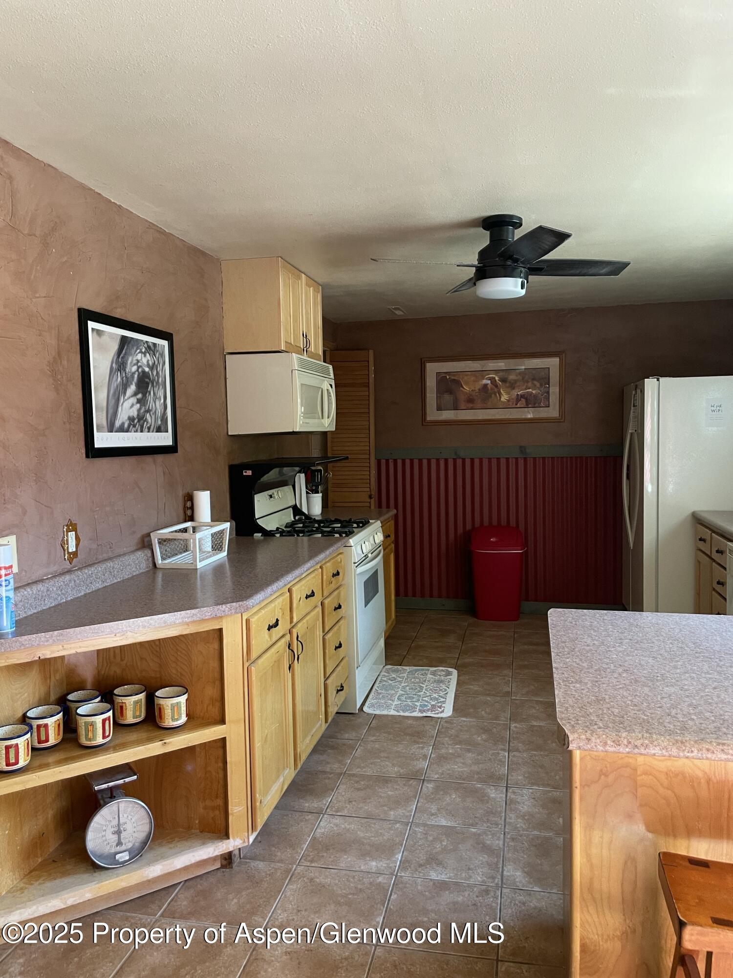 8700 County Road 300 Parachute, CO 81635 - Photo 106 of 201 a kitchen with stainless steel appliances granite countertop a stove a refrigerator and a microwave