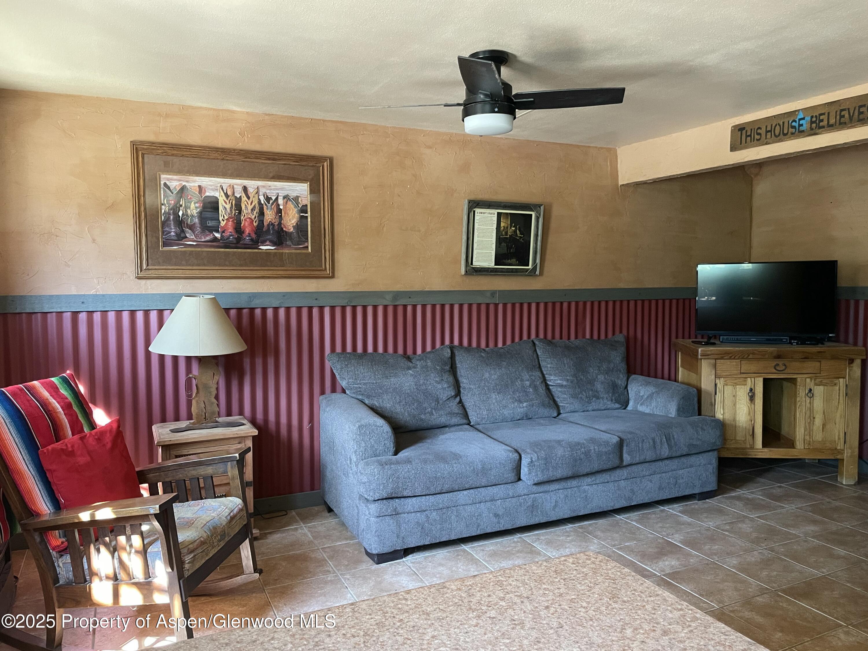 8700 County Road 300 Parachute, CO 81635 - Photo 107 of 201 a living room with furniture and a flat screen tv