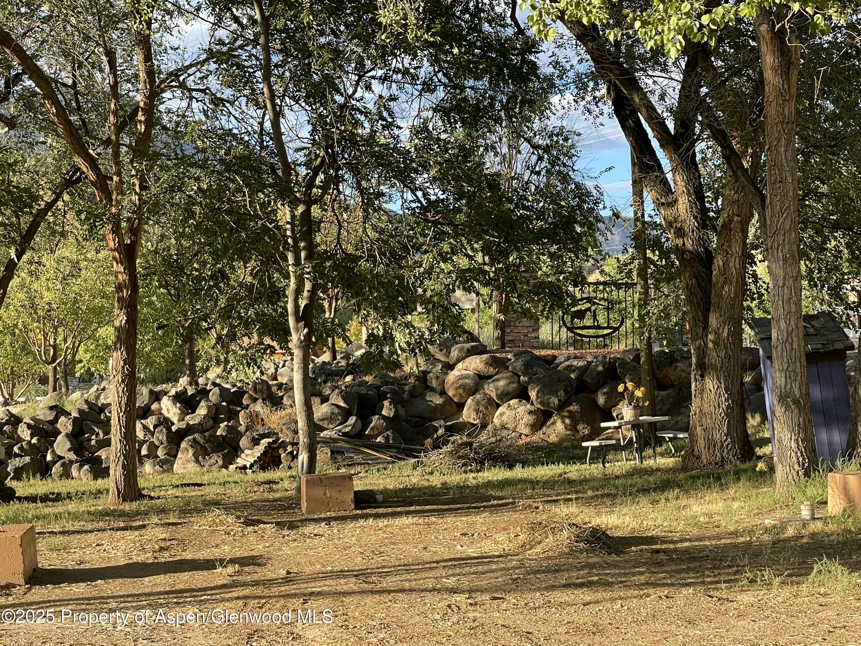 8700 County Road 300 Parachute, CO 81635 - Photo 115 of 201 a view of a yard with wooden fence