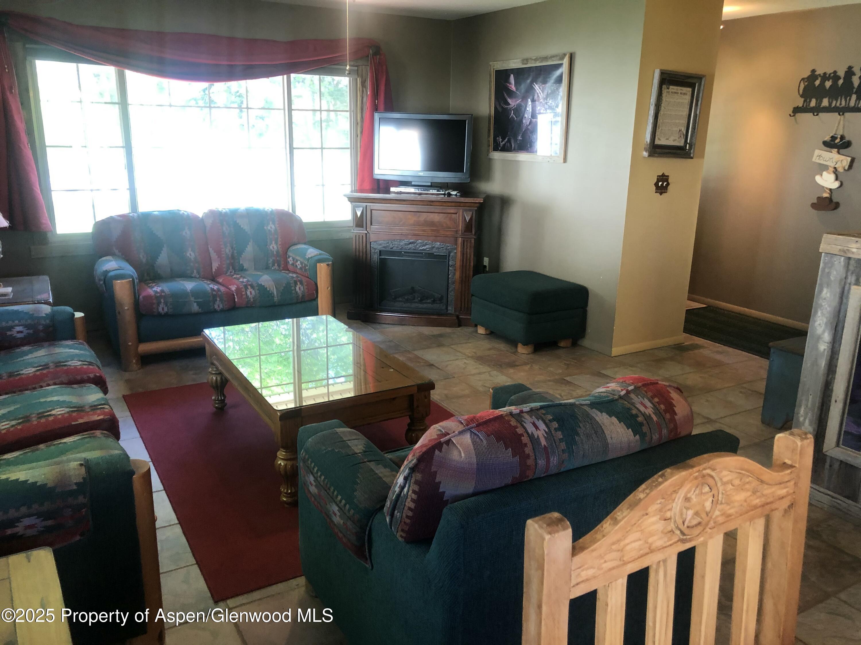 8700 County Road 300 Parachute, CO 81635 - Photo 119 of 201 a living room with furniture and a window