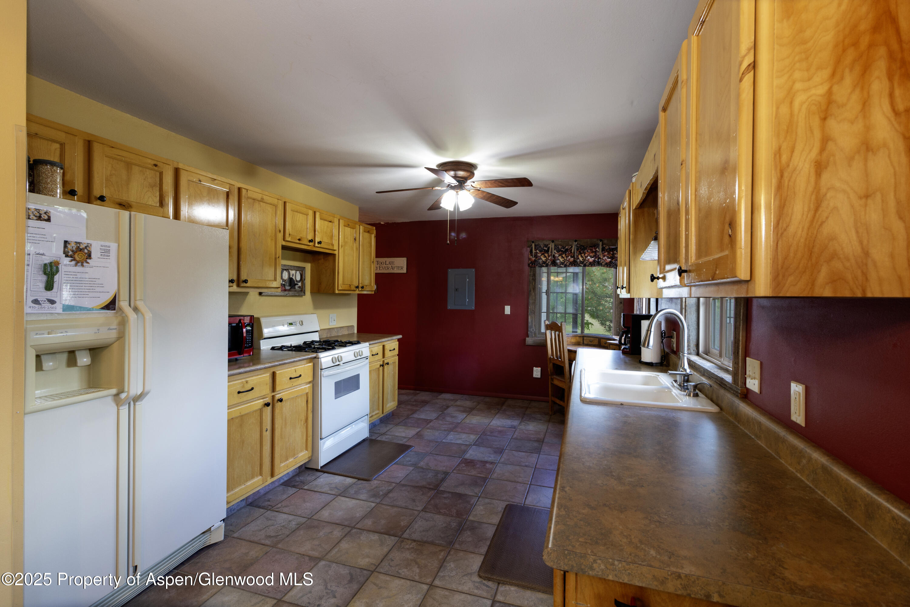 8700 County Road 300 Parachute, CO 81635 - Photo 133 of 201 a large kitchen with stainless steel appliances granite countertop a refrigerator a stove and a microwave oven with cabinets