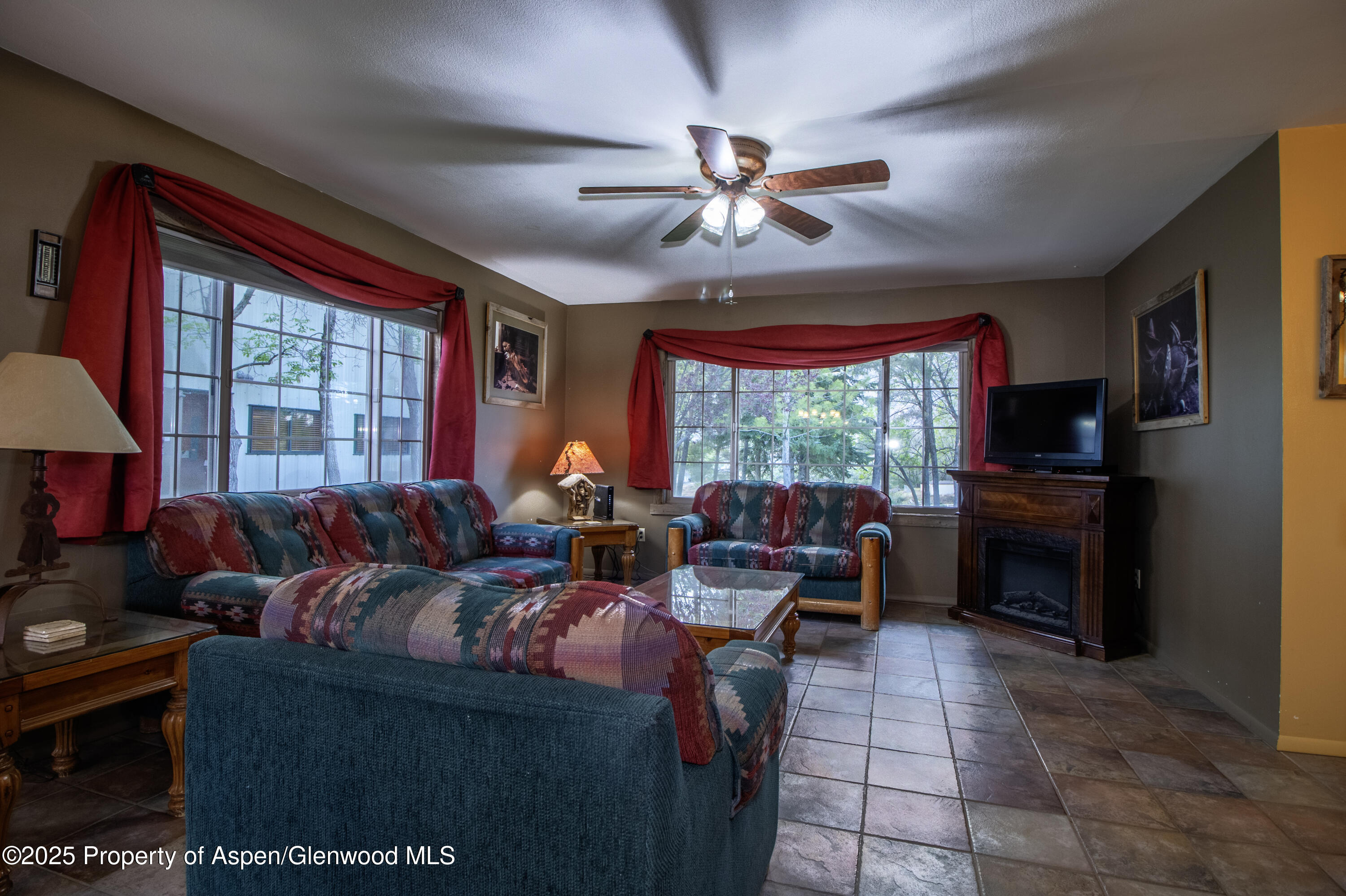 8700 County Road 300 Parachute, CO 81635 - Photo 135 of 201 a living room with furniture a fireplace and a flat screen tv