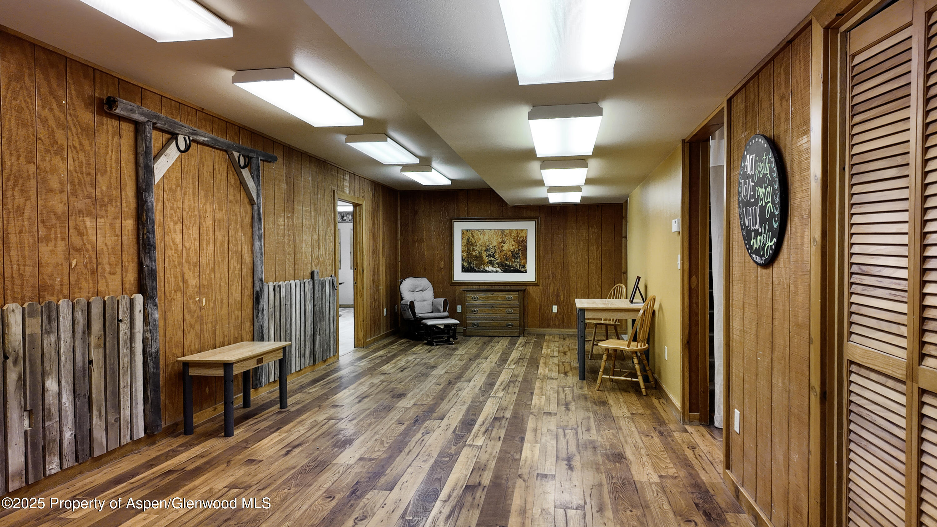 8700 County Road 300 Parachute, CO 81635 - Photo 158 of 201 a view of a hallway with wooden floor and furniture