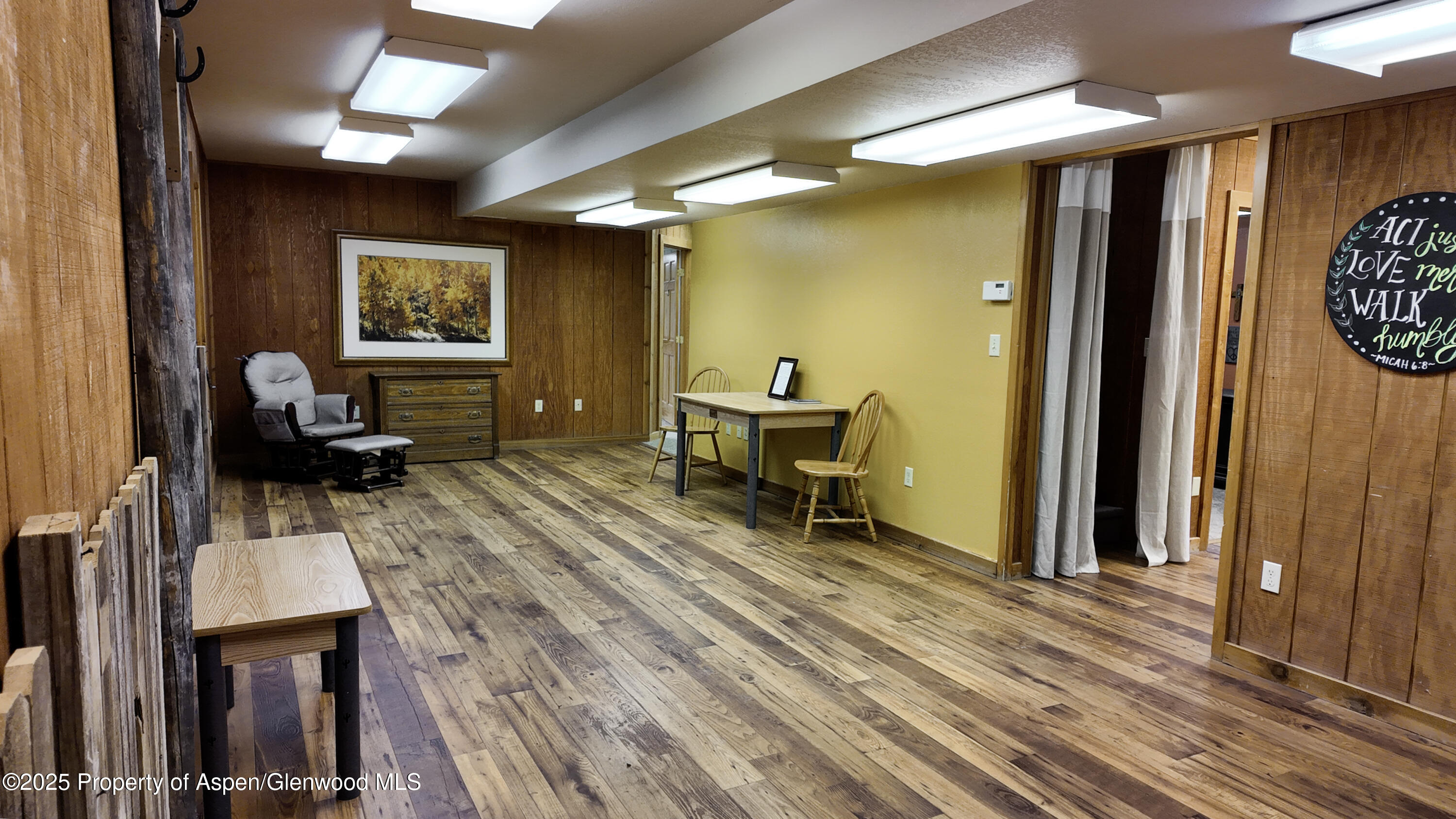 8700 County Road 300 Parachute, CO 81635 - Photo 159 of 201 a living room with furniture a wooden floor and a large window
