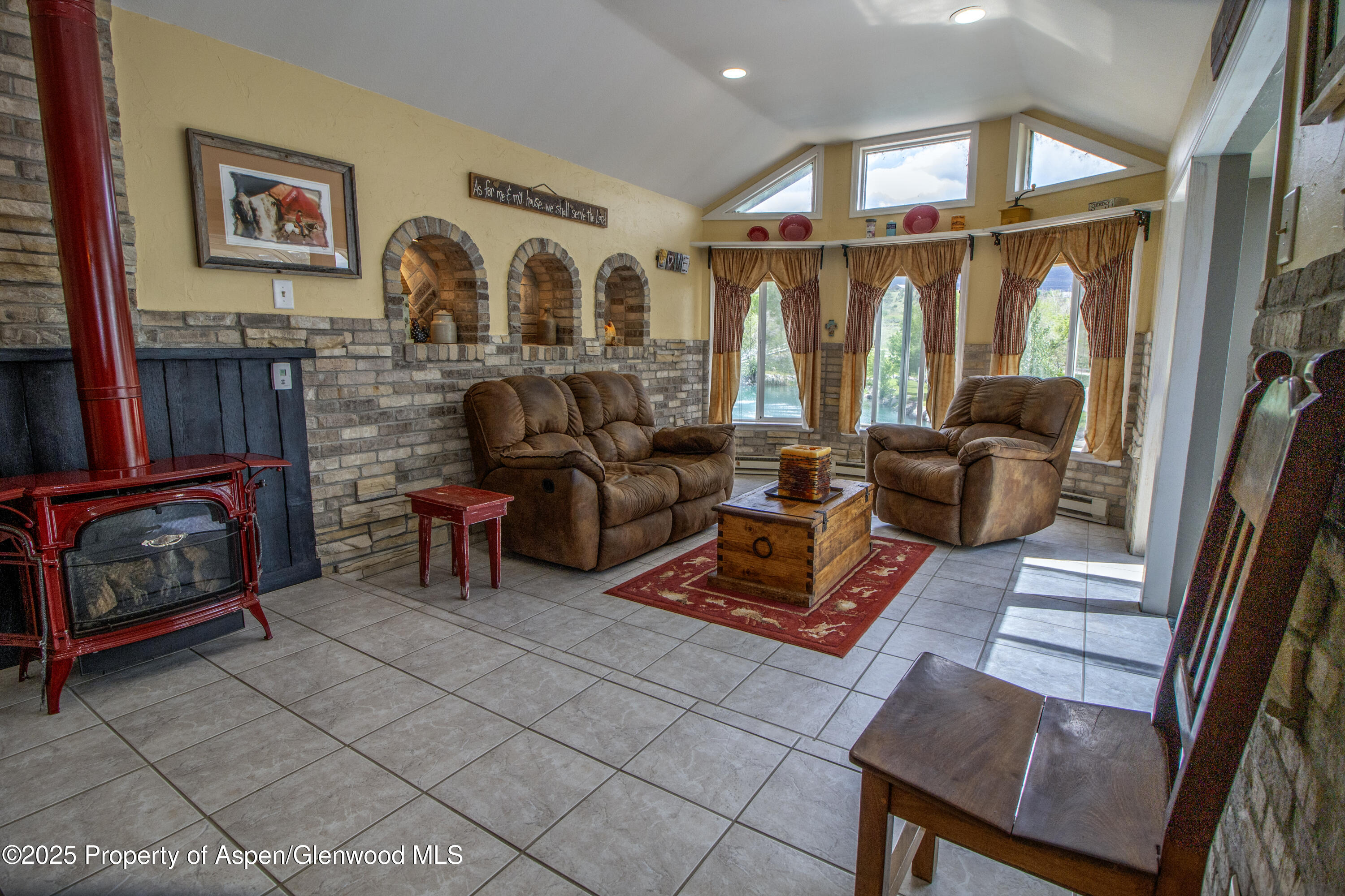 8700 County Road 300 Parachute, CO 81635 - Photo 35 of 201 a living room with furniture a rug and a floor to ceiling window