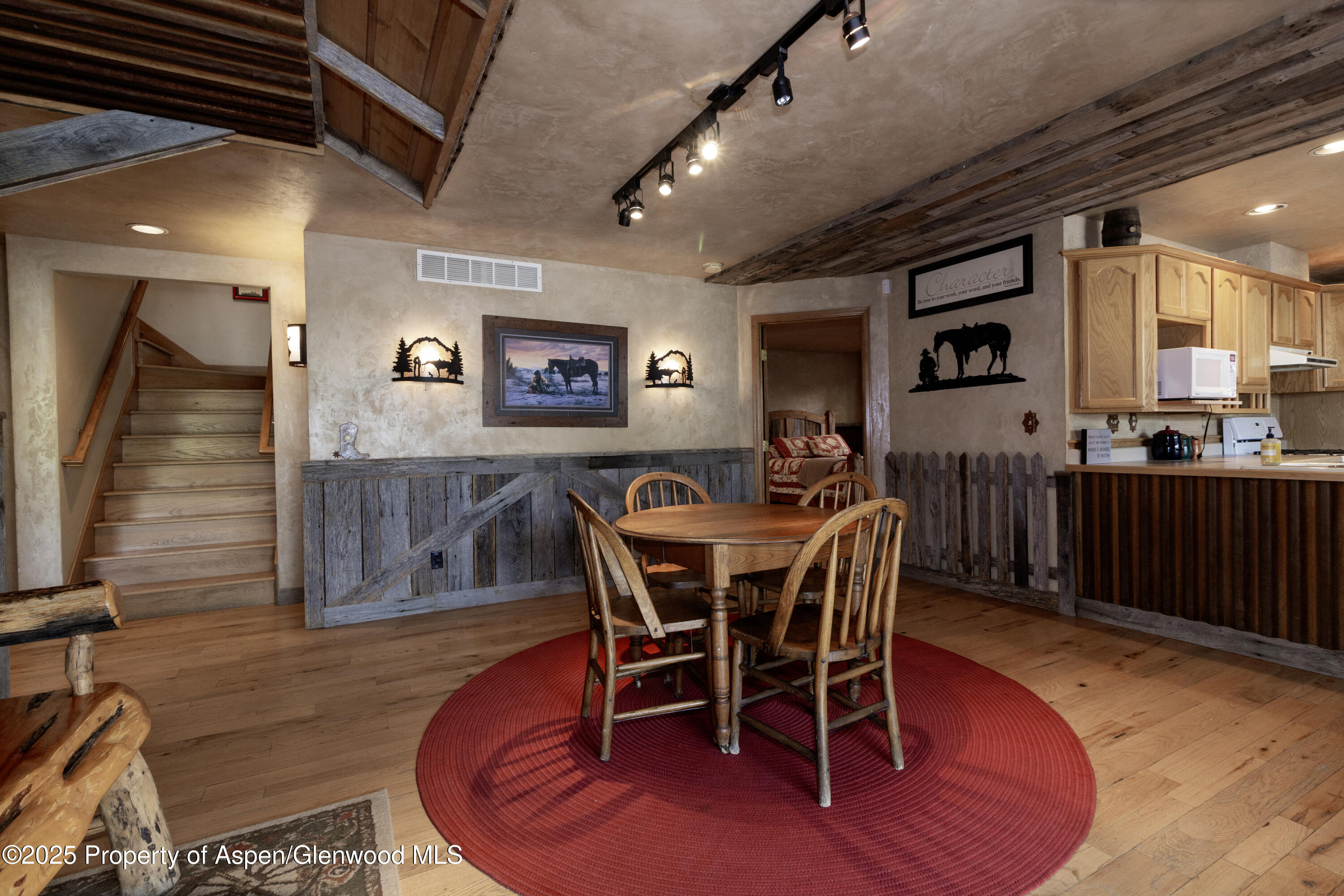 8700 County Road 300 Parachute, CO 81635 - Photo 52 of 201 a dining room with furniture a rug and a chandelier