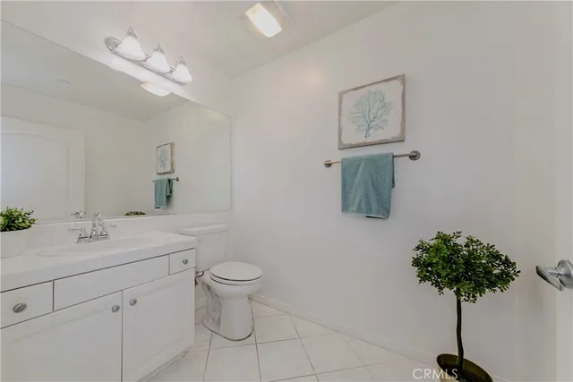 a bedroom with bed and a potted plant