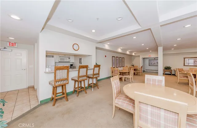 a view of a hallway with wooden floor and a bathroom