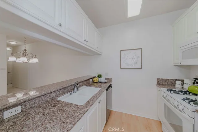 a kitchen with a stove a refrigerator and a sink