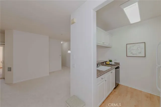 a view of a room with a mirror and wooden floor