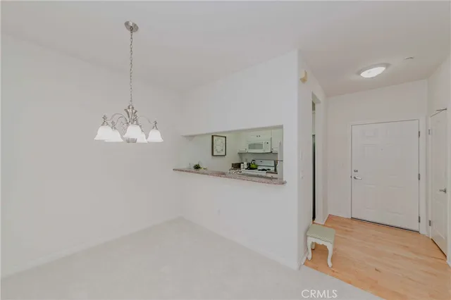 a living room with furniture a flat screen tv and a window