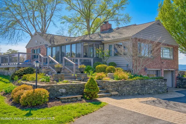 a view of a house with backyard and sitting area