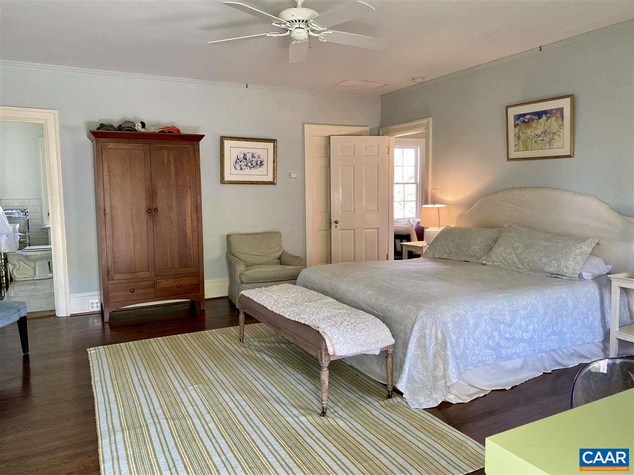 1101 Rugby Road Charlottesville, VA 22903 - Photo 19 of 43 a bedroom with a bed and a chandelier
