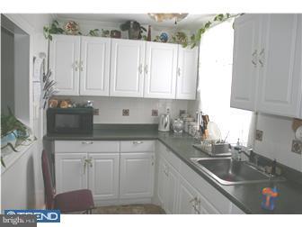 246 Heather Road Upper Darby, PA 19082 - Photo 7 of 7 a kitchen with stainless steel appliances granite countertop a sink a refrigerator and a white cabinets
