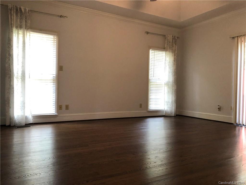 426 St Michaels Way, Unit 15 Fort Mill, SC 29708 - Photo 14 of 25 a view of an empty room with wooden floor and a window