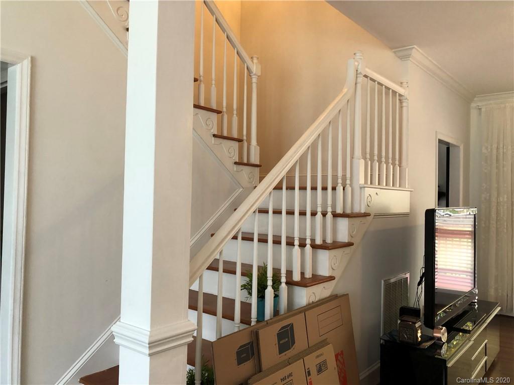 426 St Michaels Way, Unit 15 Fort Mill, SC 29708 - Photo 22 of 25 a view of staircase with lots of frames on wall and a window
