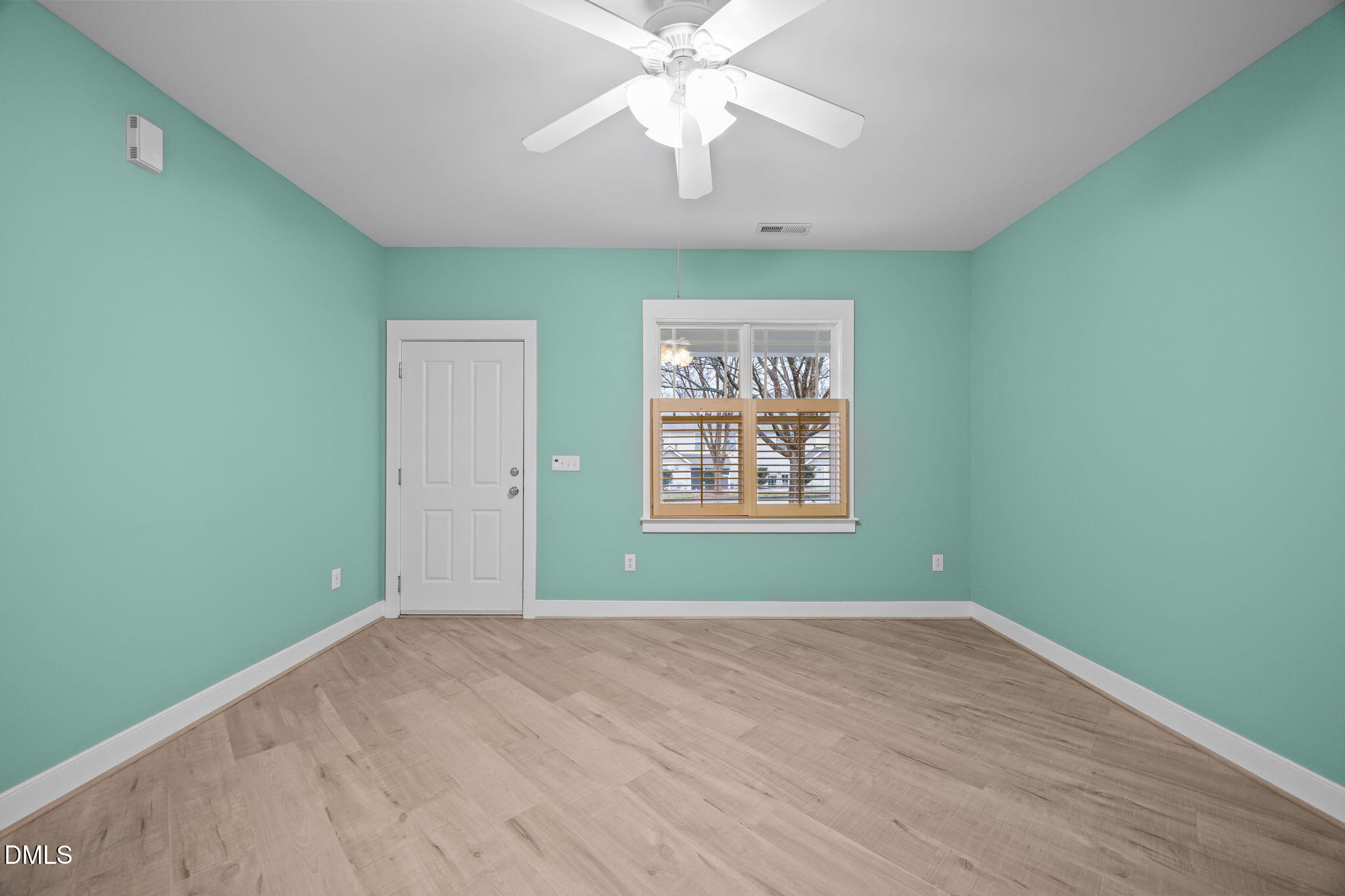 2817 Falls River Avenue Raleigh, NC 27614 - Photo 11 of 60 an empty room with a window and a fan