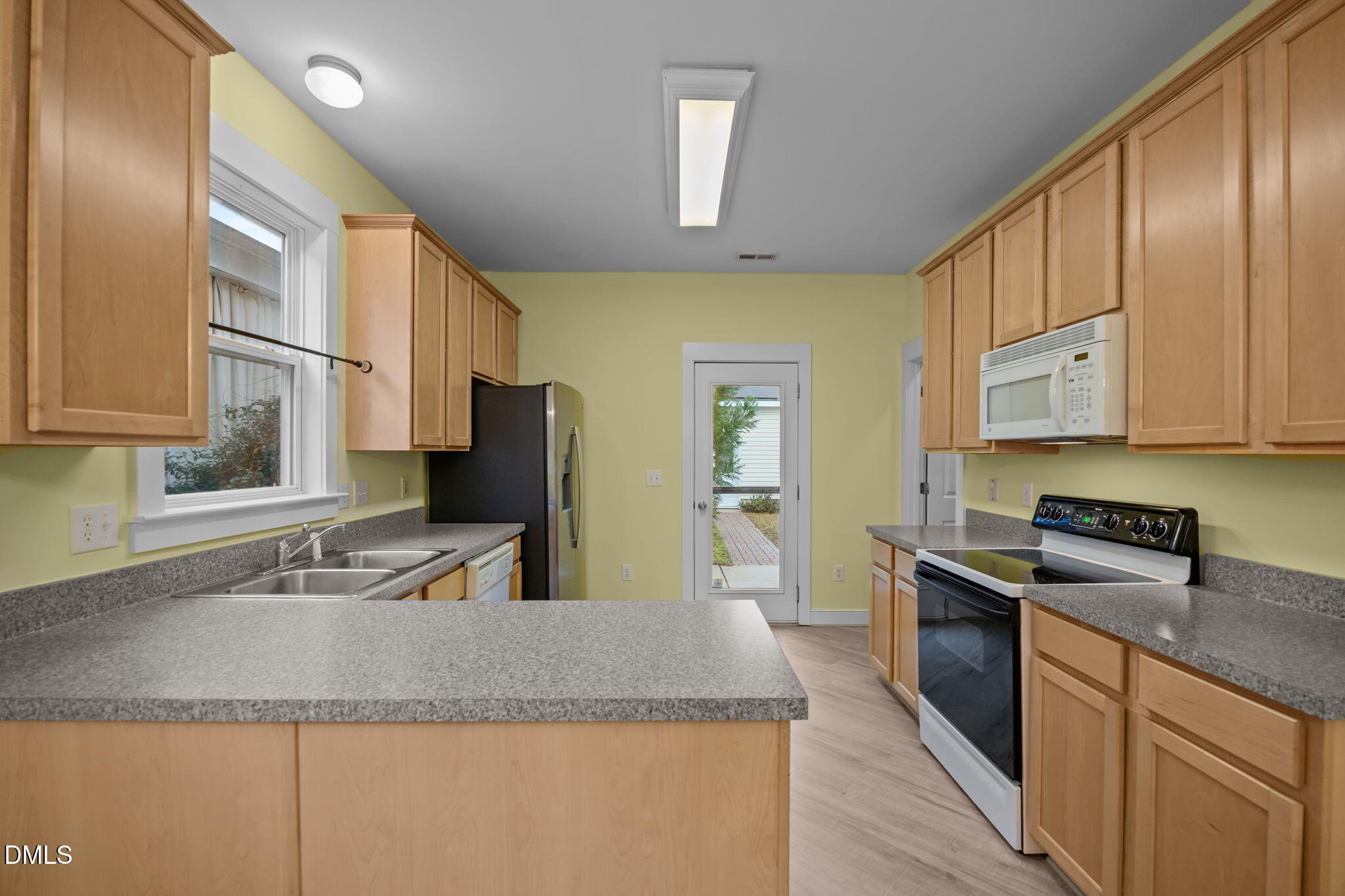 2817 Falls River Avenue Raleigh, NC 27614 - Photo 25 of 60 a kitchen with stainless steel appliances granite countertop a sink stove and refrigerator