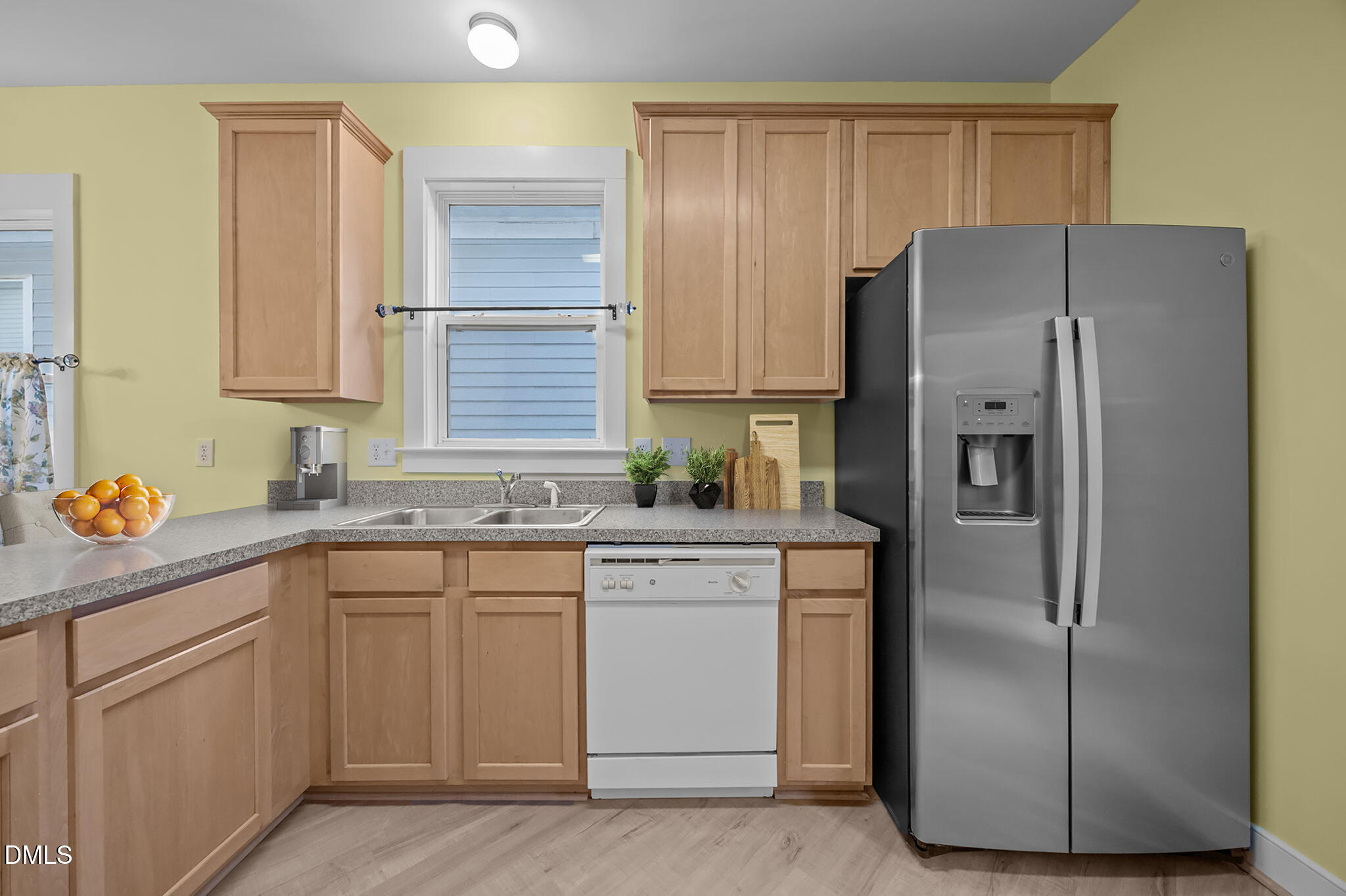 2817 Falls River Avenue Raleigh, NC 27614 - Photo 28 of 60 a kitchen with a refrigerator sink and cabinets