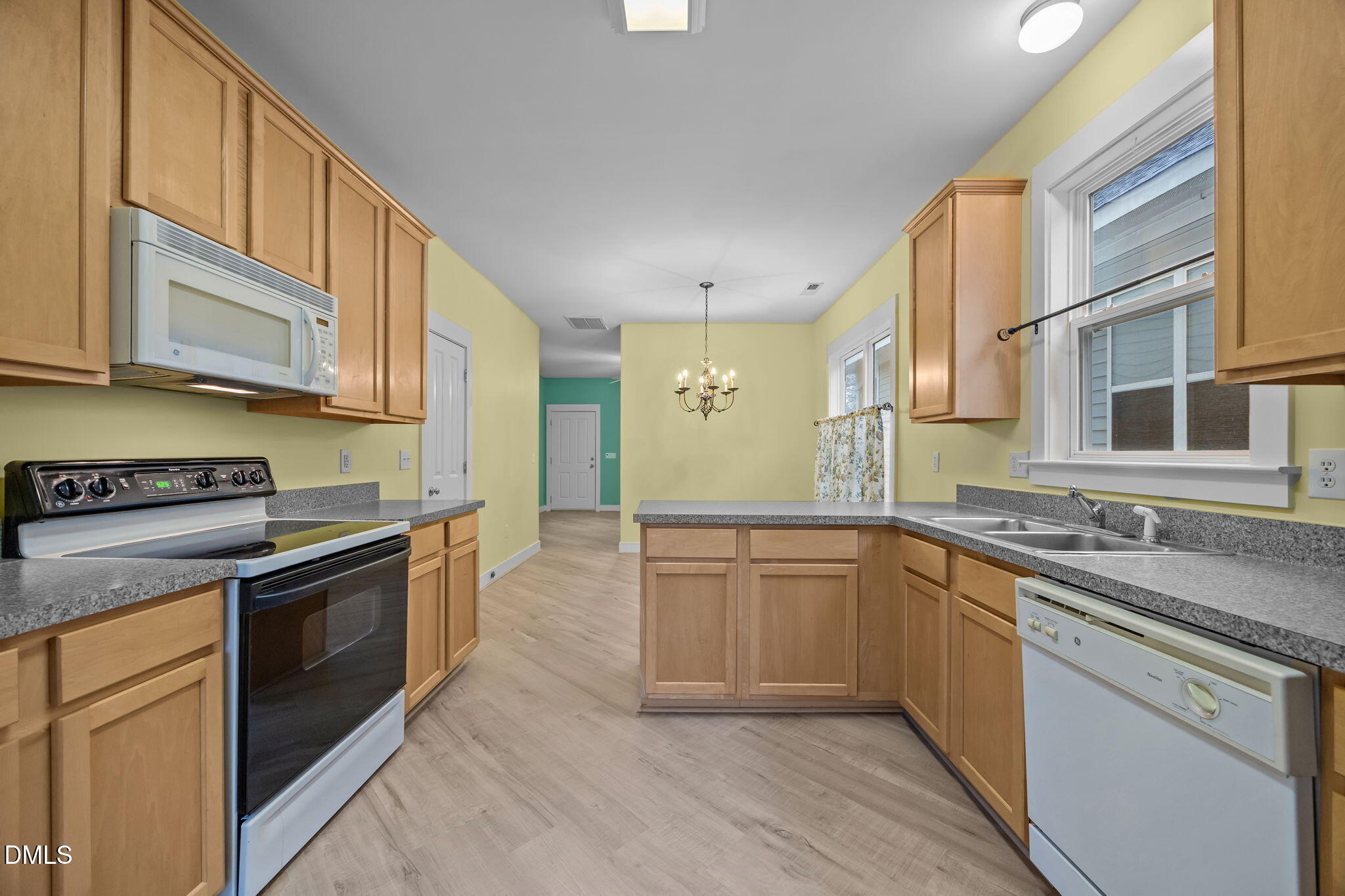 2817 Falls River Avenue Raleigh, NC 27614 - Photo 30 of 60 a kitchen with stainless steel appliances granite countertop a stove a sink and a granite counter tops