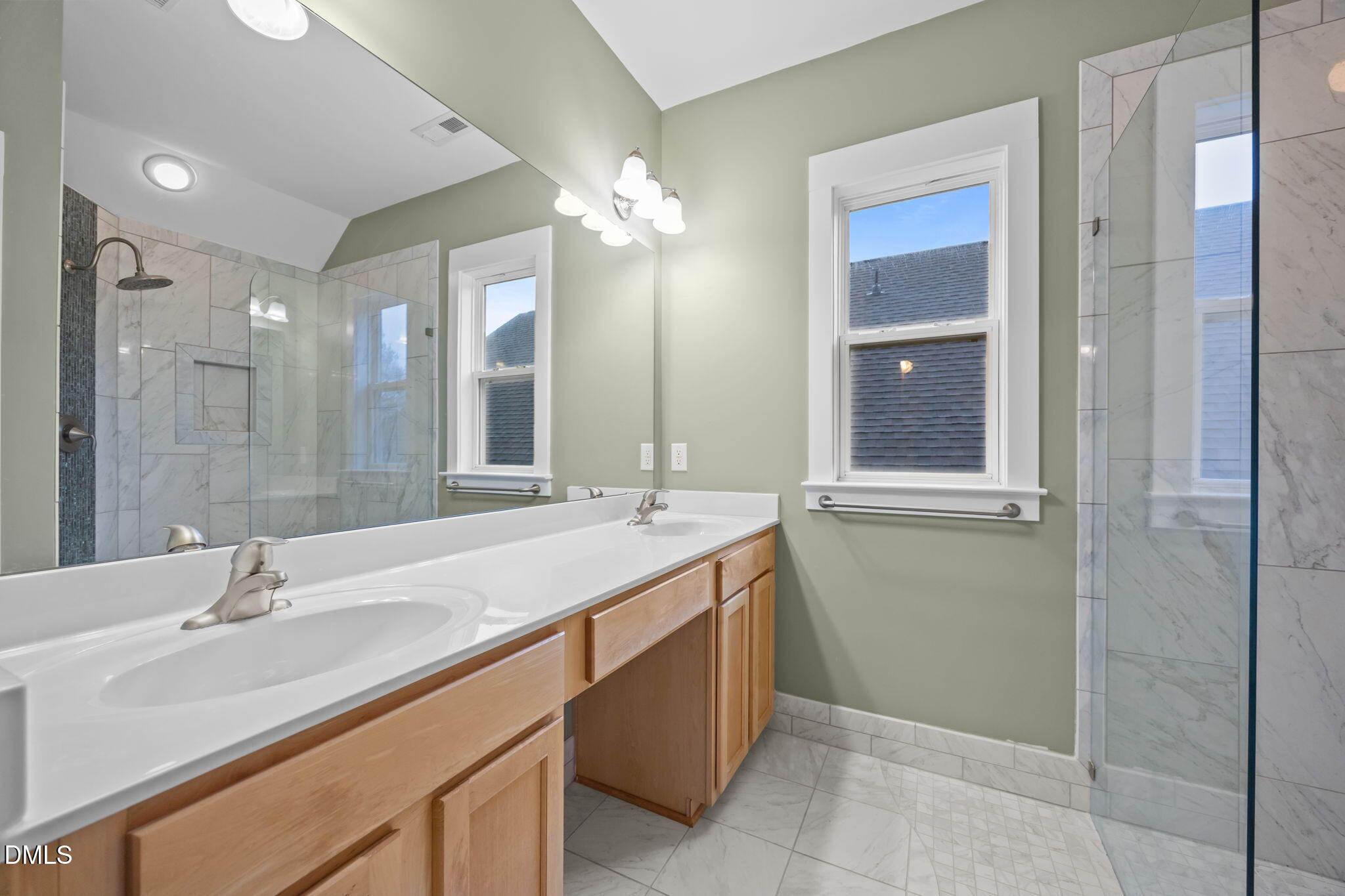 2817 Falls River Avenue Raleigh, NC 27614 - Photo 36 of 60 a bathroom with a double vanity sink mirror and shower