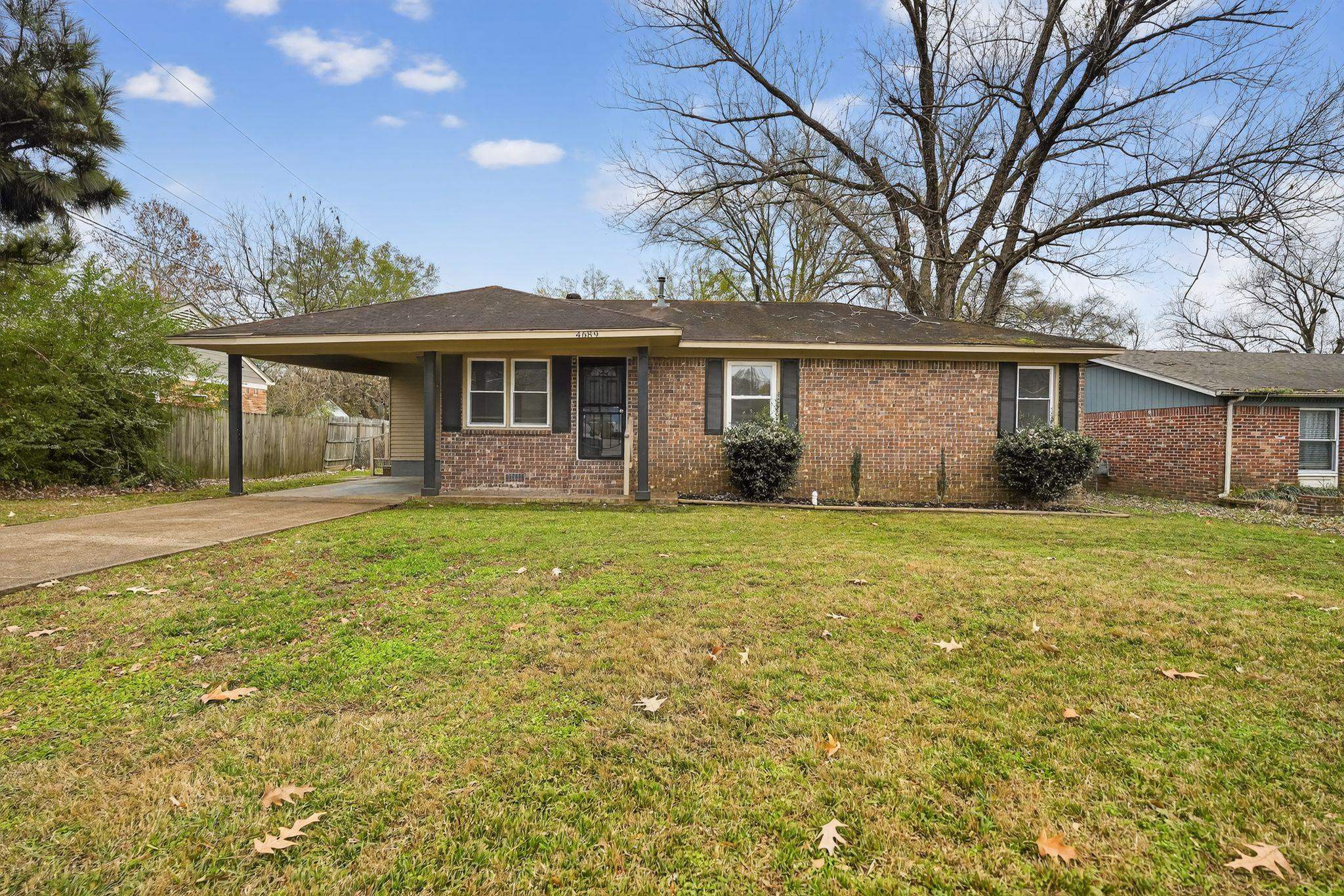 4689 Raleigh Lagrange Road Memphis, TN 38128 - Photo 1 of 30 Ranch-style home featuring driveway, brick siding, and an attached carport