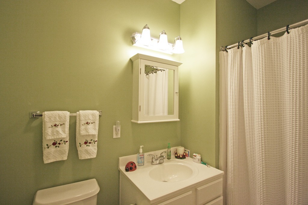 190 Chickering, Unit 210D North Andover, MA 01845 - Photo 11 of 16 a bathroom with a sink mirror and toilet