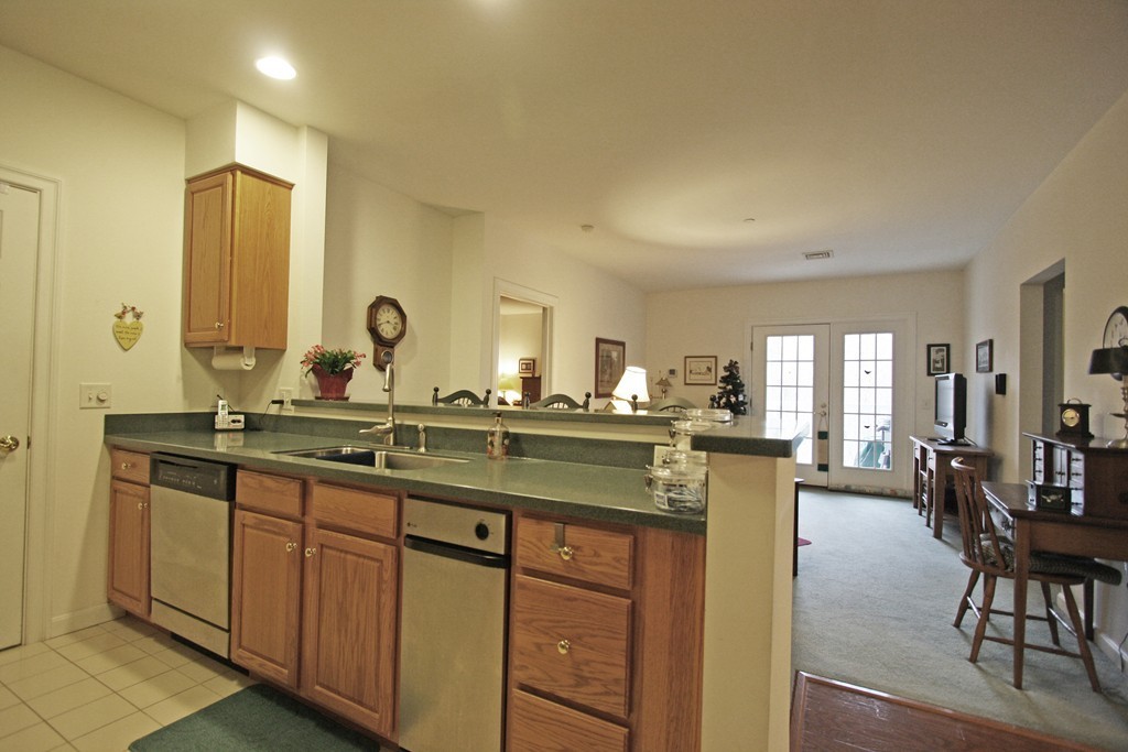 190 Chickering, Unit 210D North Andover, MA 01845 - Photo 5 of 16 a bathroom with a granite countertop sink and a large mirror