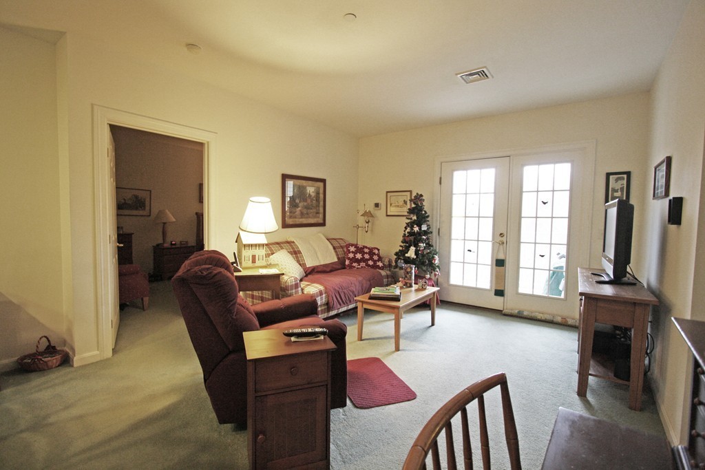 190 Chickering, Unit 210D North Andover, MA 01845 - Photo 6 of 16 a living room with fireplace furniture and a flat screen tv