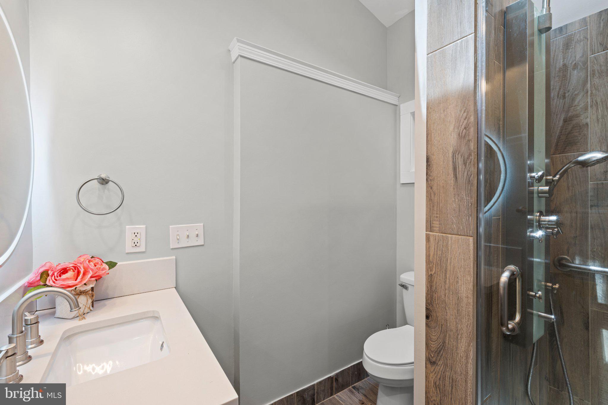 8405 Shirley Road Spotsylvania, VA 22551 - Photo 23 of 42 a bathroom with a sink toilet and shower