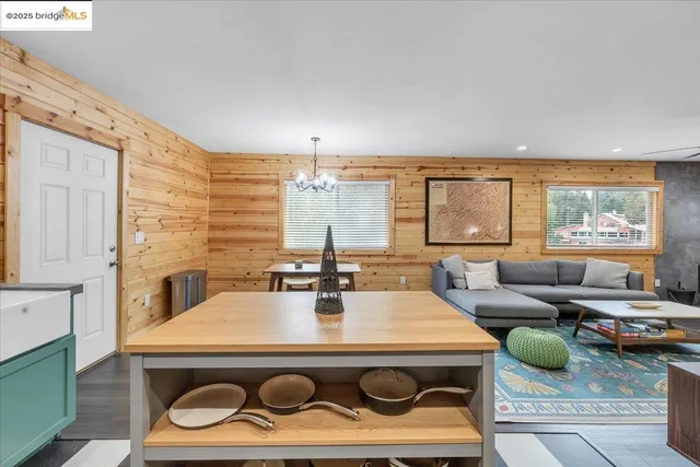 a living room with furniture a large window and a table